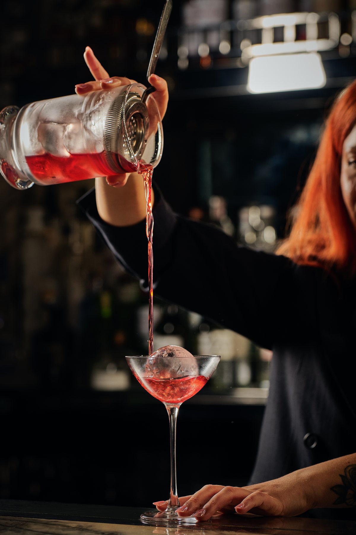 Bartender pouring a cocktail